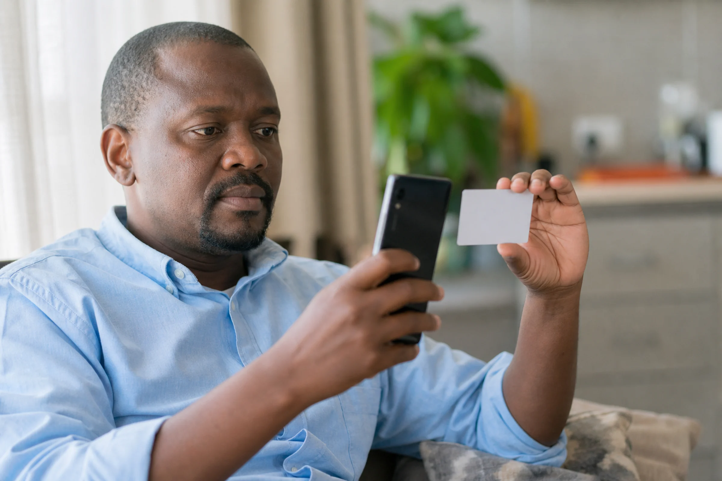 A man photographs his ID card with his phone